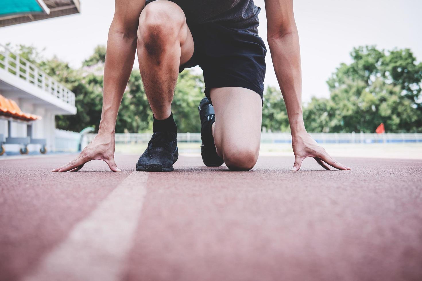 Running preparing to race on running track photo