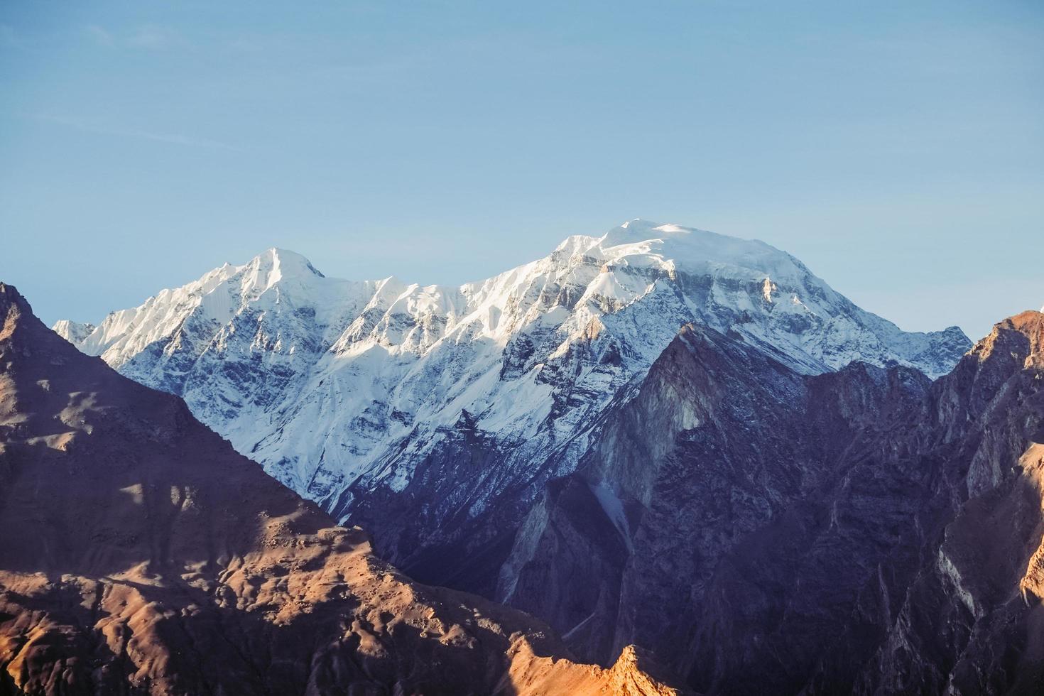 Morning sunlight shining on snowcapped mountain photo