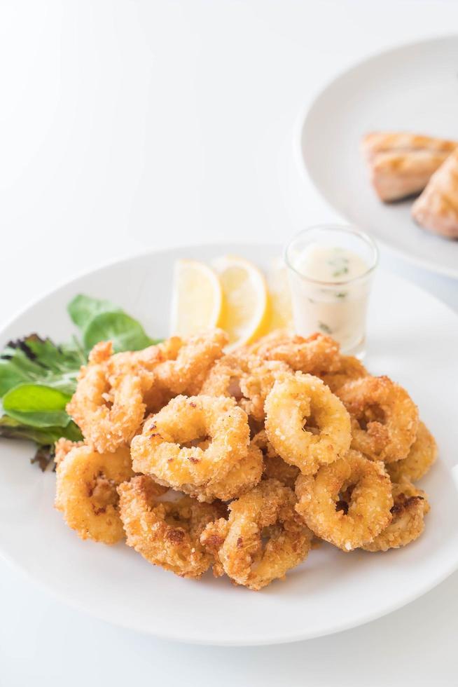 Fried calamari rings on plate photo