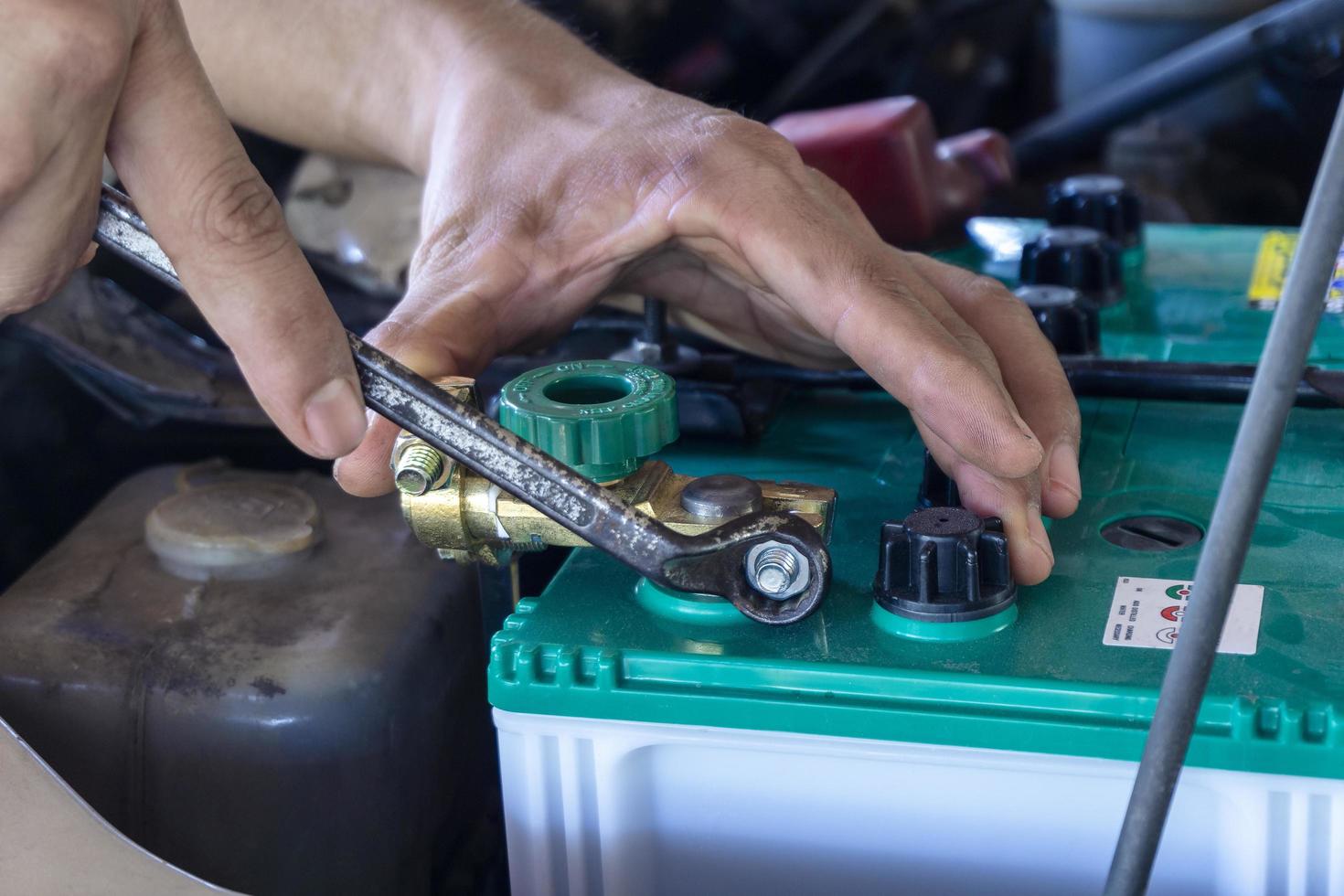 Close-up of technician work on car battery photo