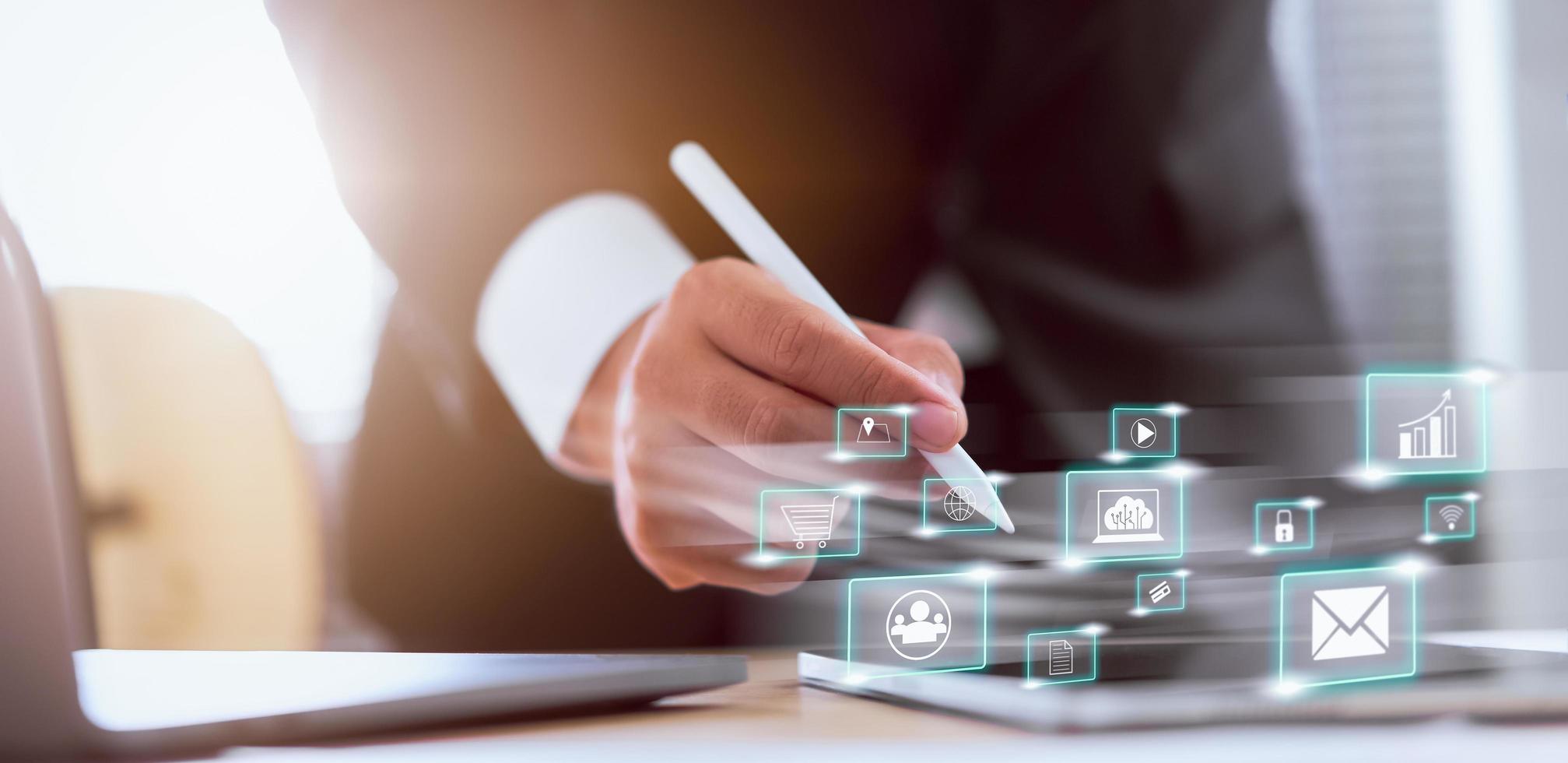 Businessman using social media working on tablet computer photo