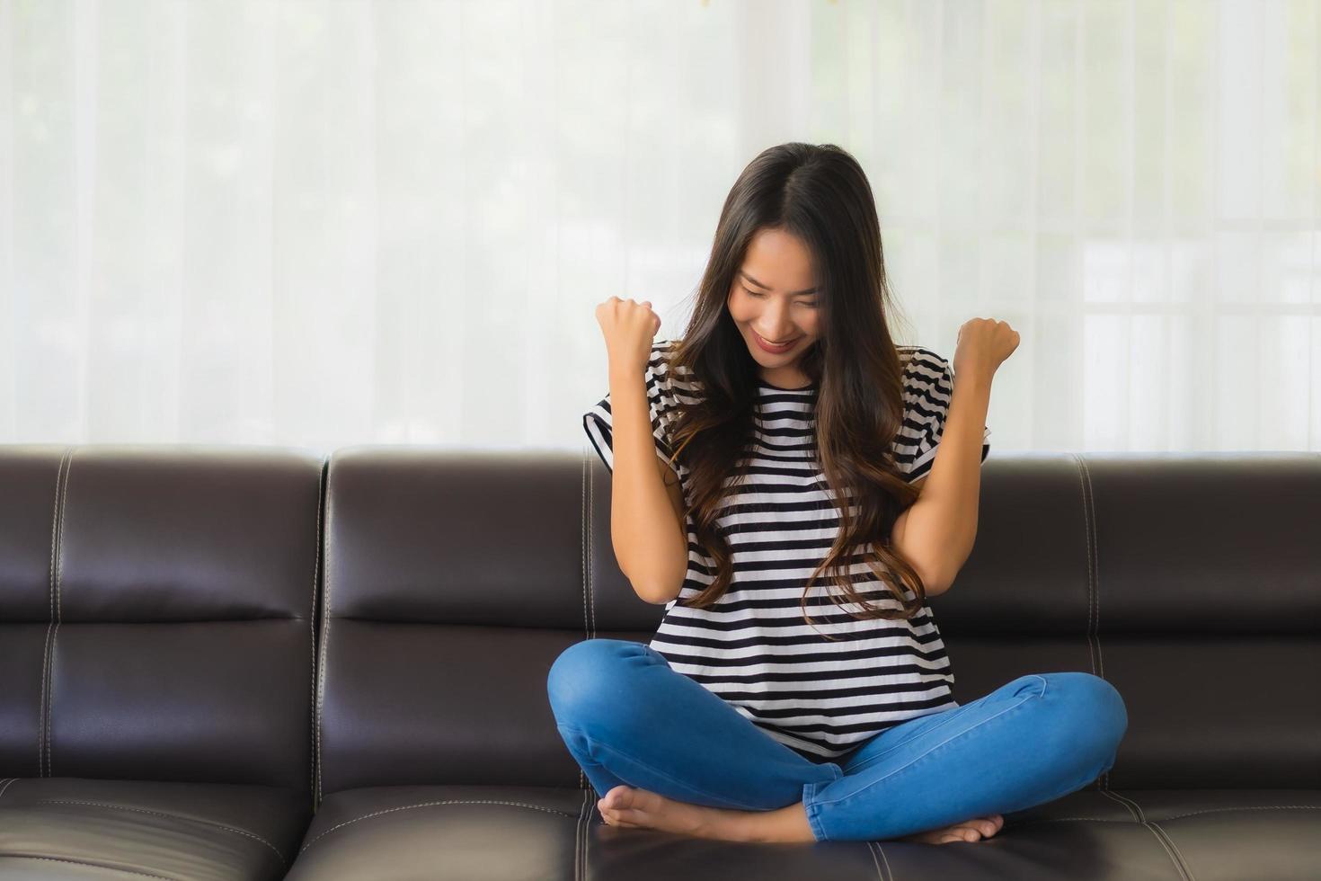 Portrait of happy woman on sofa photo