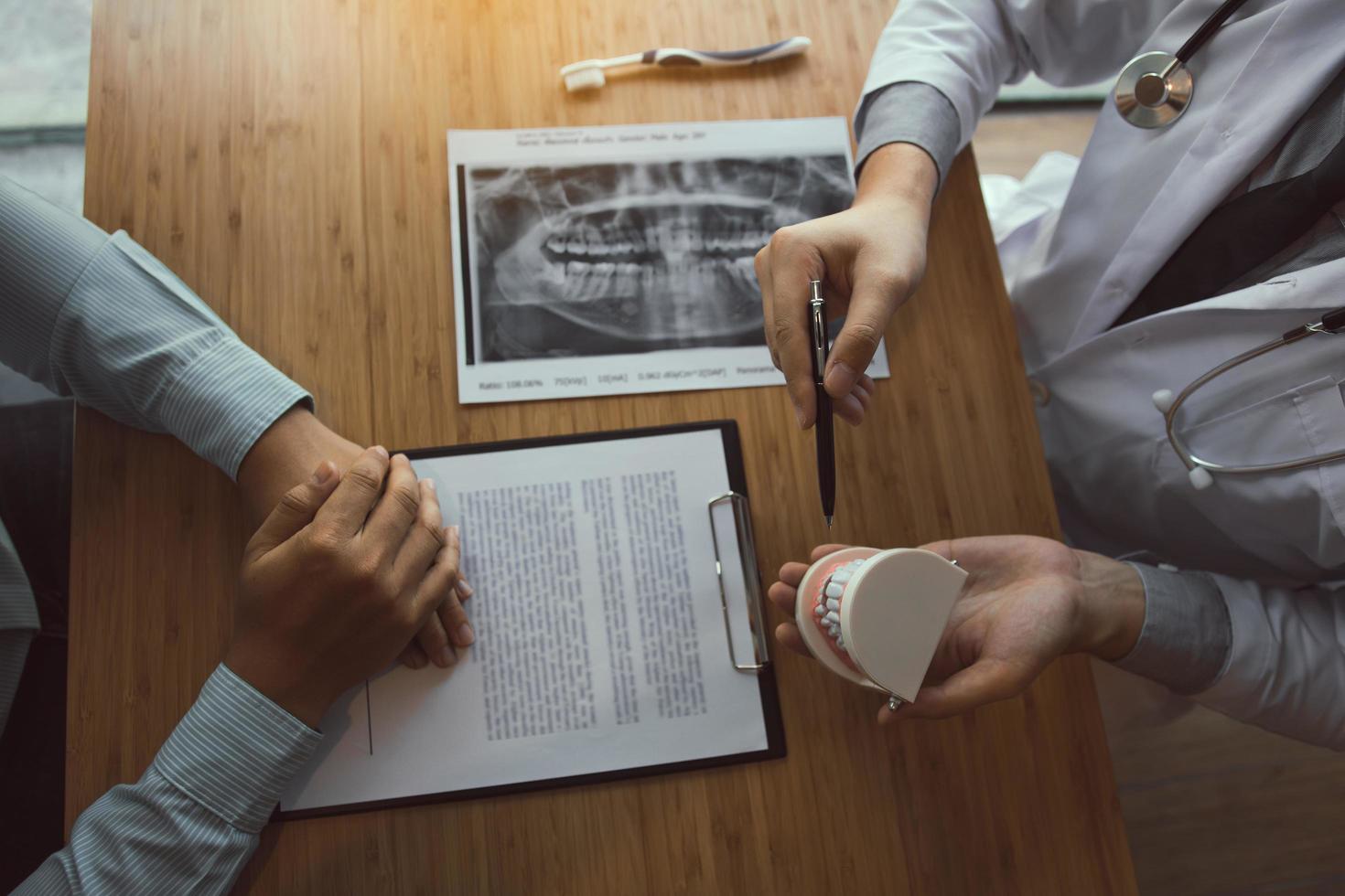 Dentist explaining care plan to patient  photo