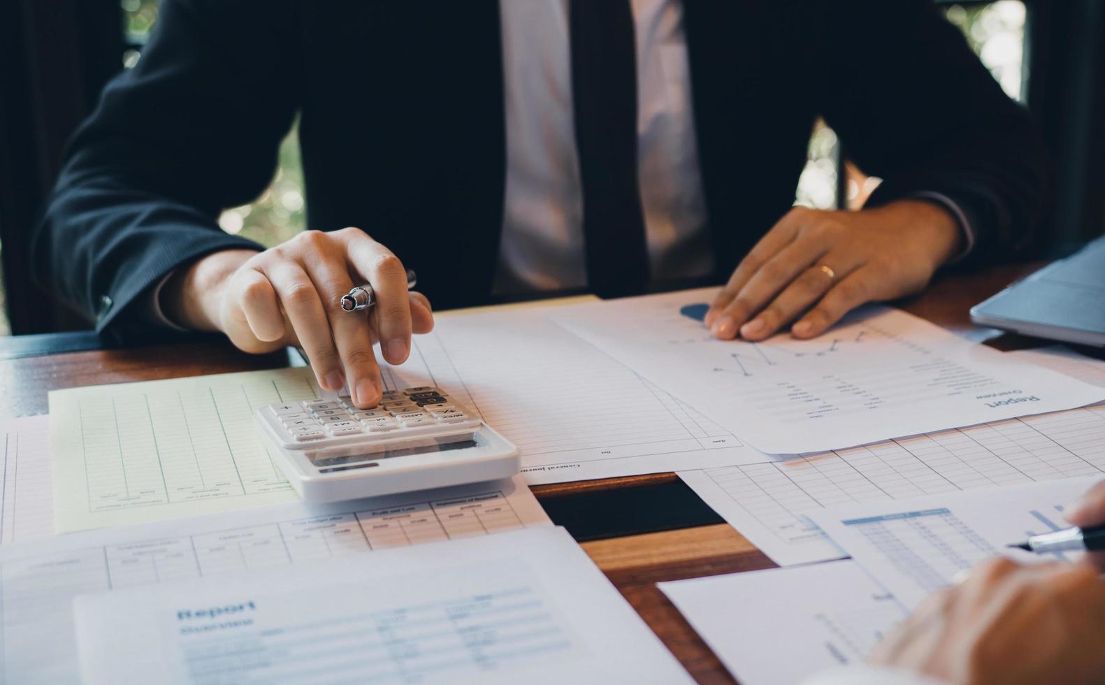 Businessman calculating cost of company's sales  photo