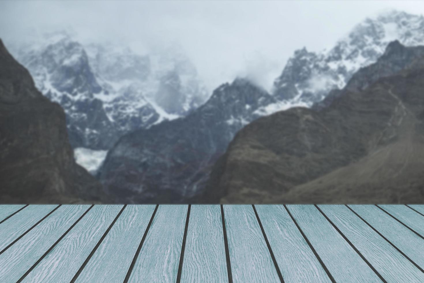 Wooden planks against snow capped mountain range photo