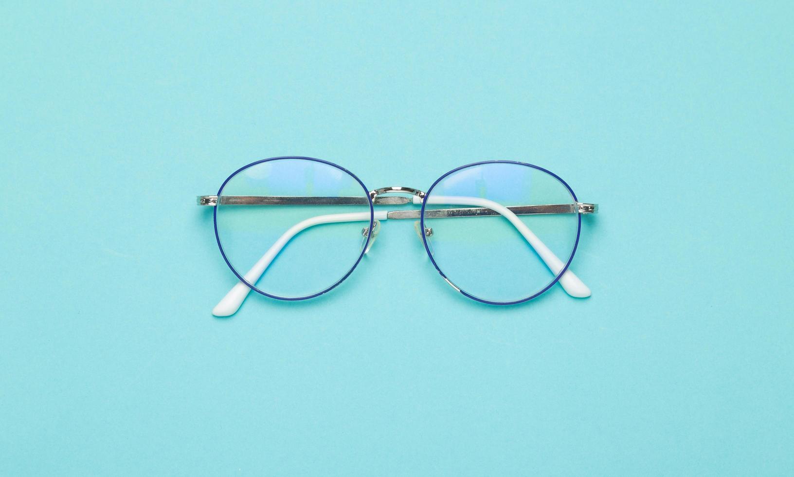 Glasses on blue background  photo