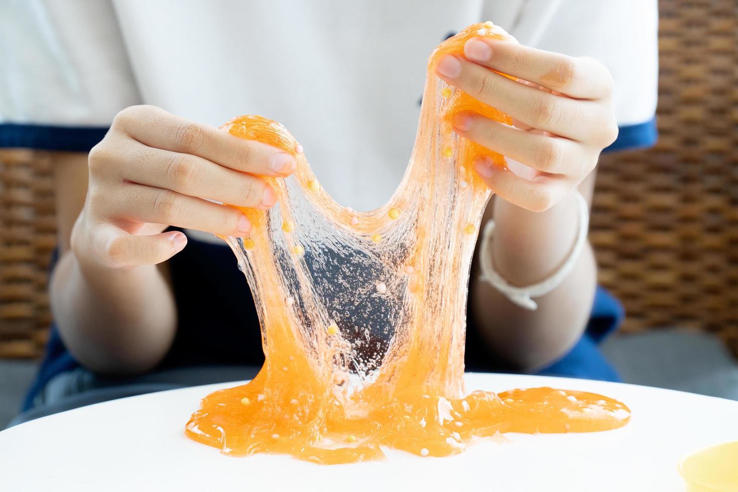 Hands playing with homemade slime photo