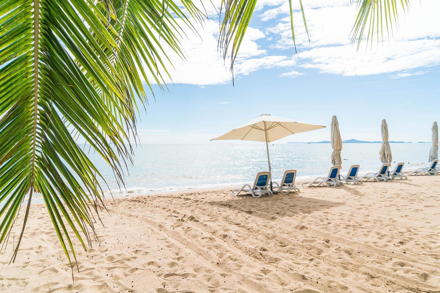 Tropical beach scene with open umbrella photo