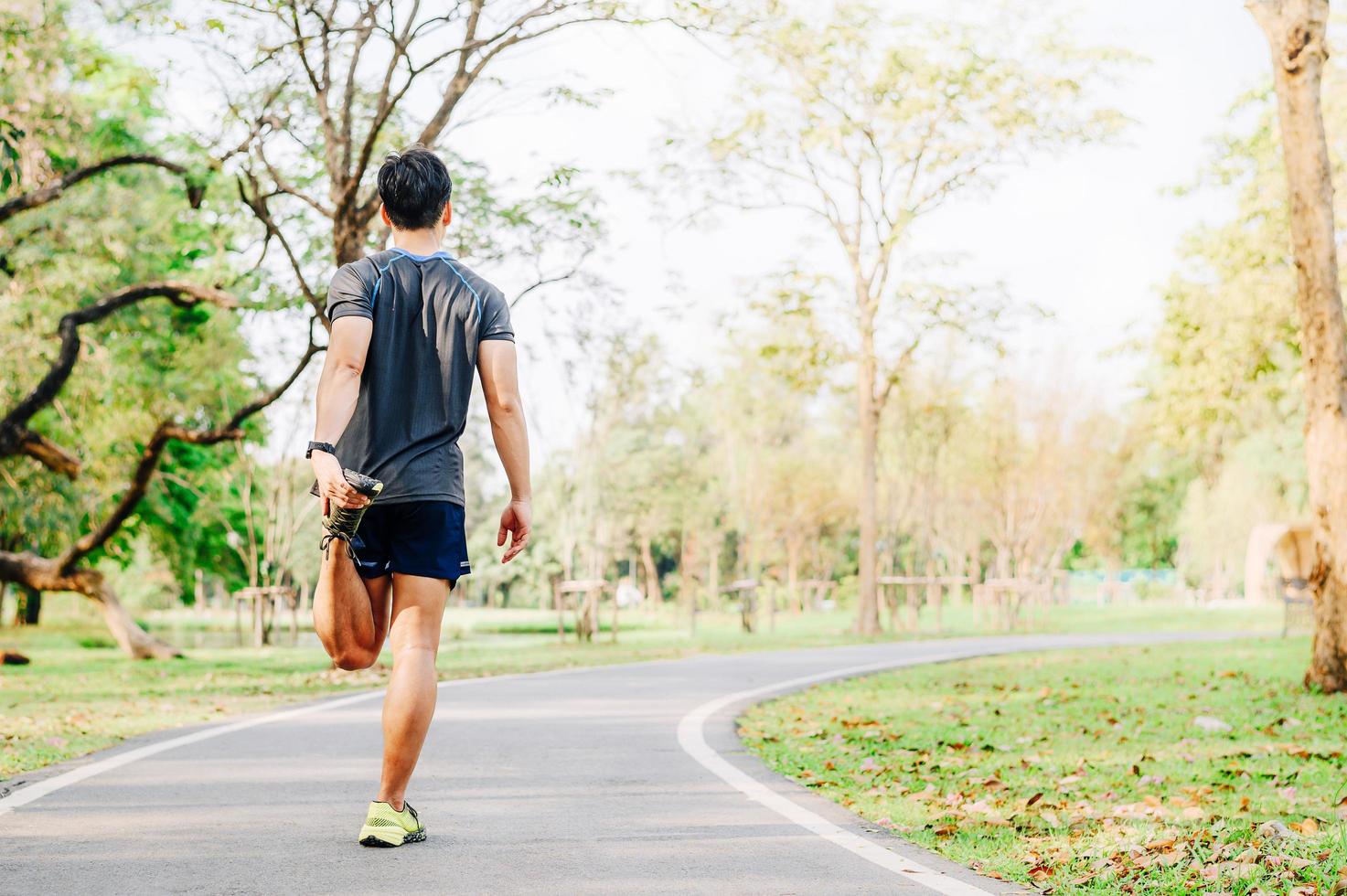 Male runner doing stretching exercise photo