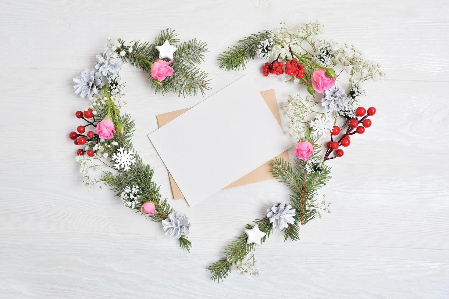 Mockup of heart-shaped wreath with blank paper. photo