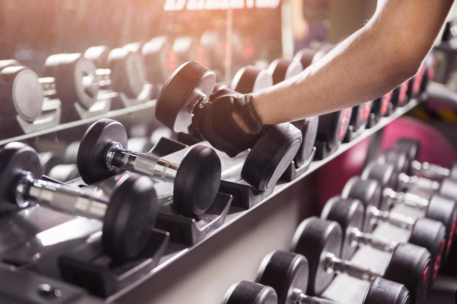Hand with rows of dumbbells photo