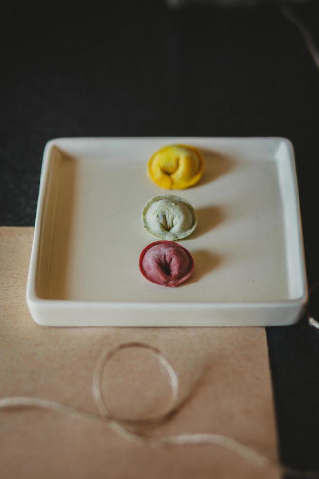 Colorful tortellini on plate photo