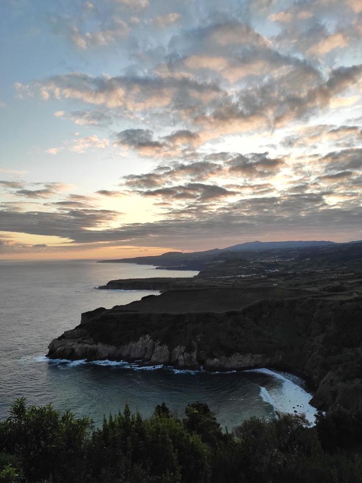 Ocean cliffs under sunset photo