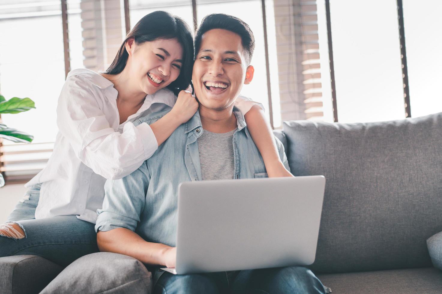 Happy Asian couple having a good time at home Stock Photo