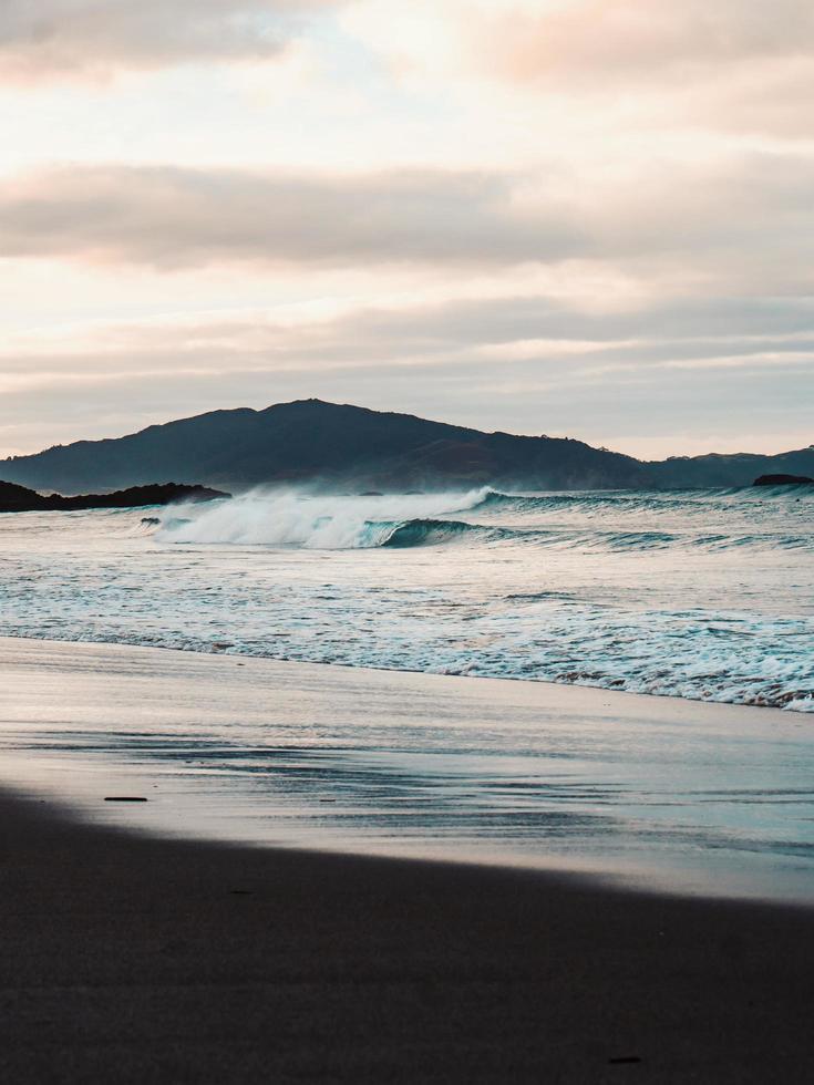 Ocean waves crashing on shore photo