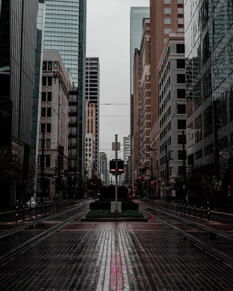 Empty street between buildings in city photo