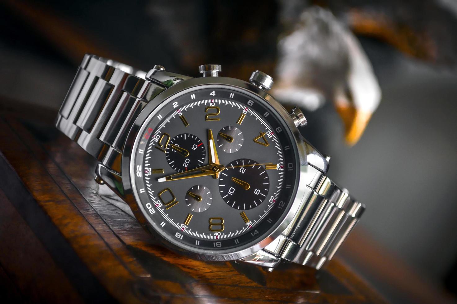 Silver linked bracelet and black round chronograph watch photo