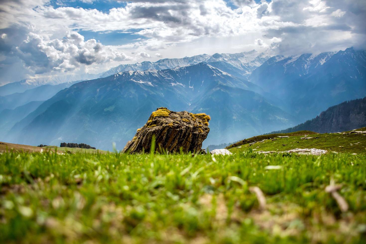 Boulder in foreground of mountain scene photo