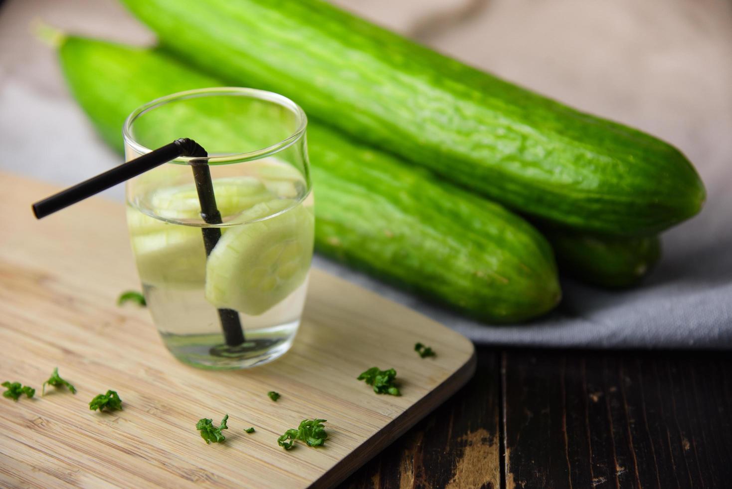 Cucumber water in glass with cucumbers photo