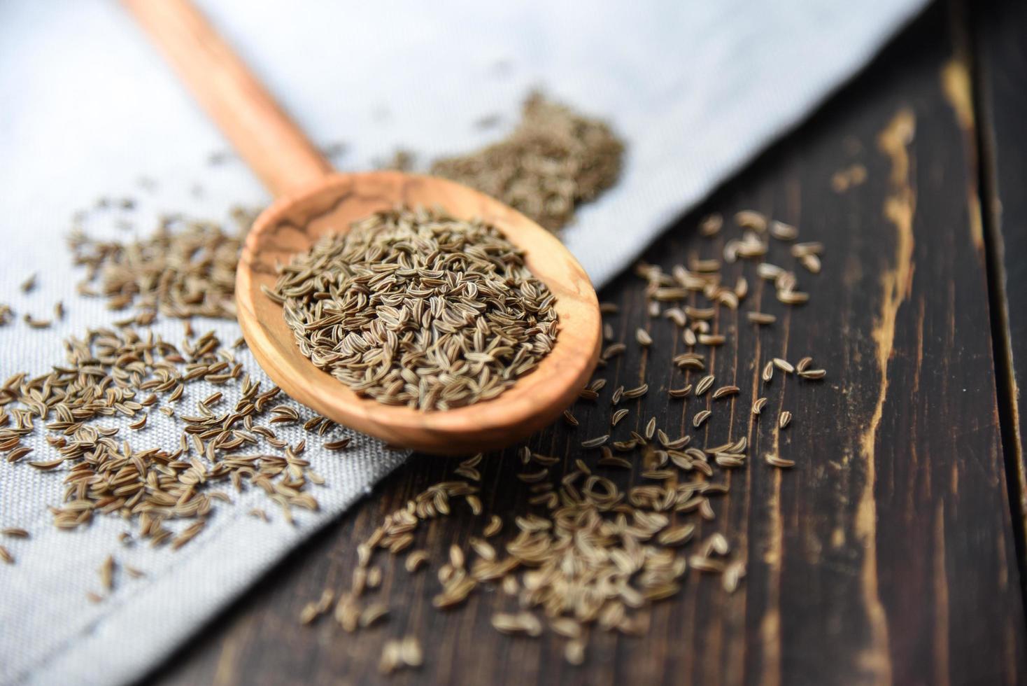 Caraway seeds on wooden spoon photo