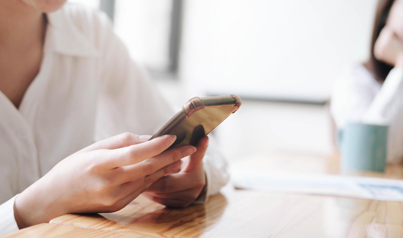 Closeup image of Asian woman holding smart phone photo