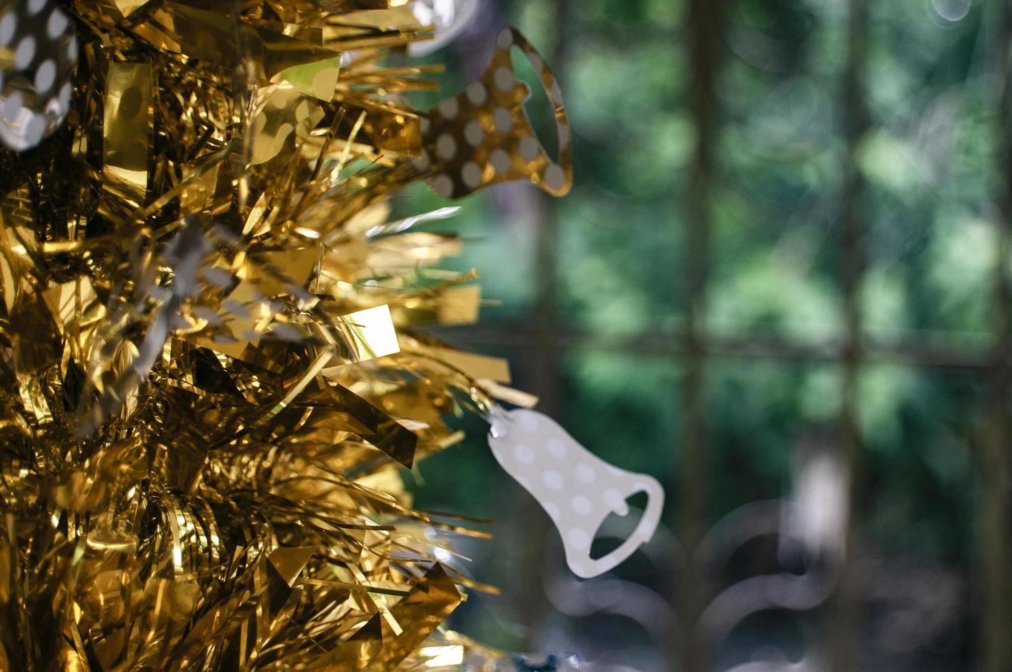 Gold tinsel decor with white flower ornament. photo