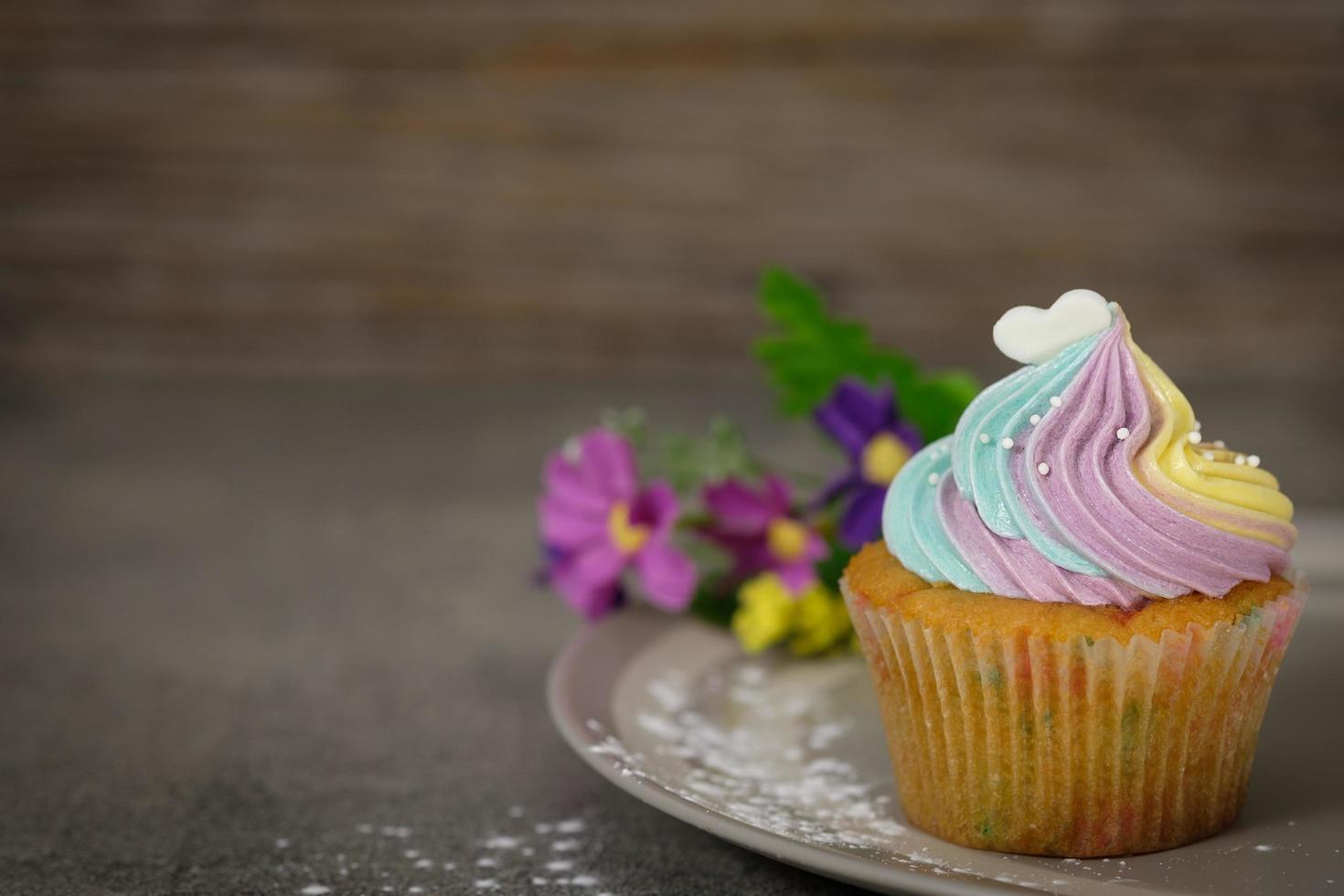 Colorful cupcake on gray plate photo