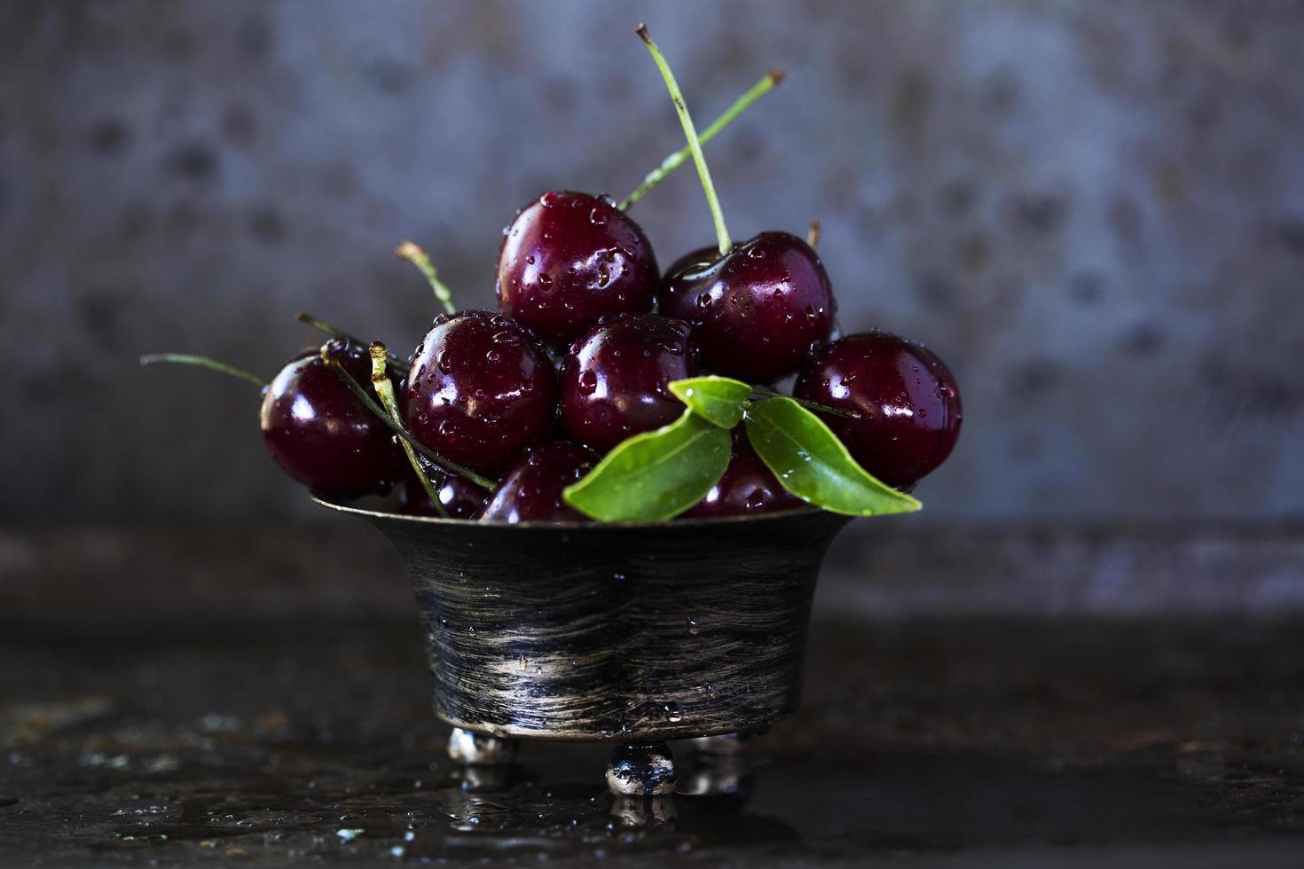 Red cherries in stainless steel bowl photo