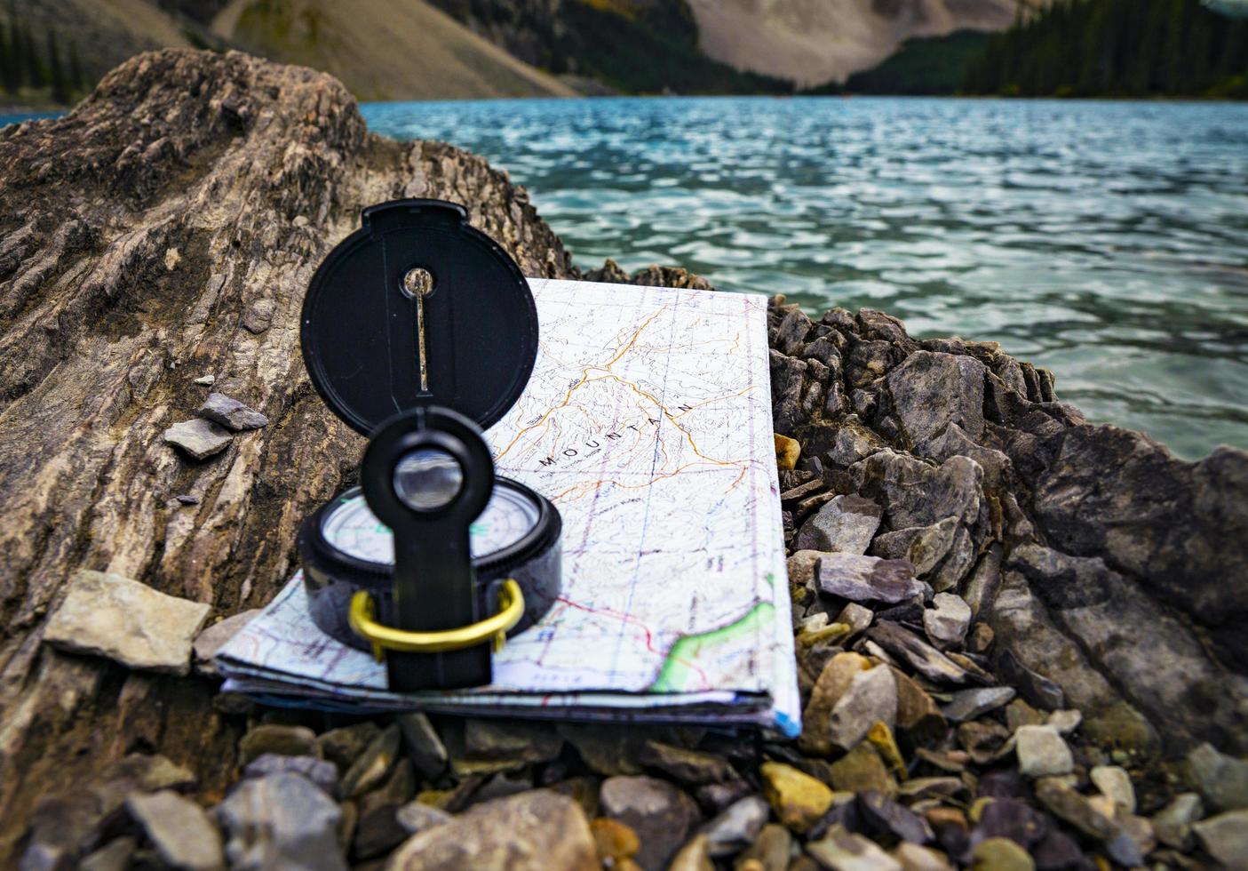 Compass and map on rocks photo