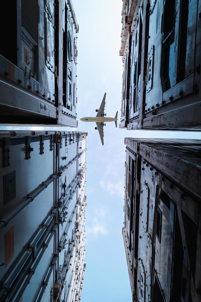 Plane flying over storage containers  photo