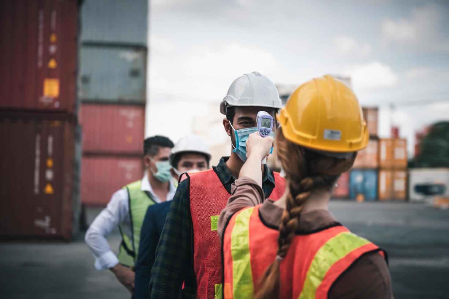 Thermometer scanning at construction site.  photo