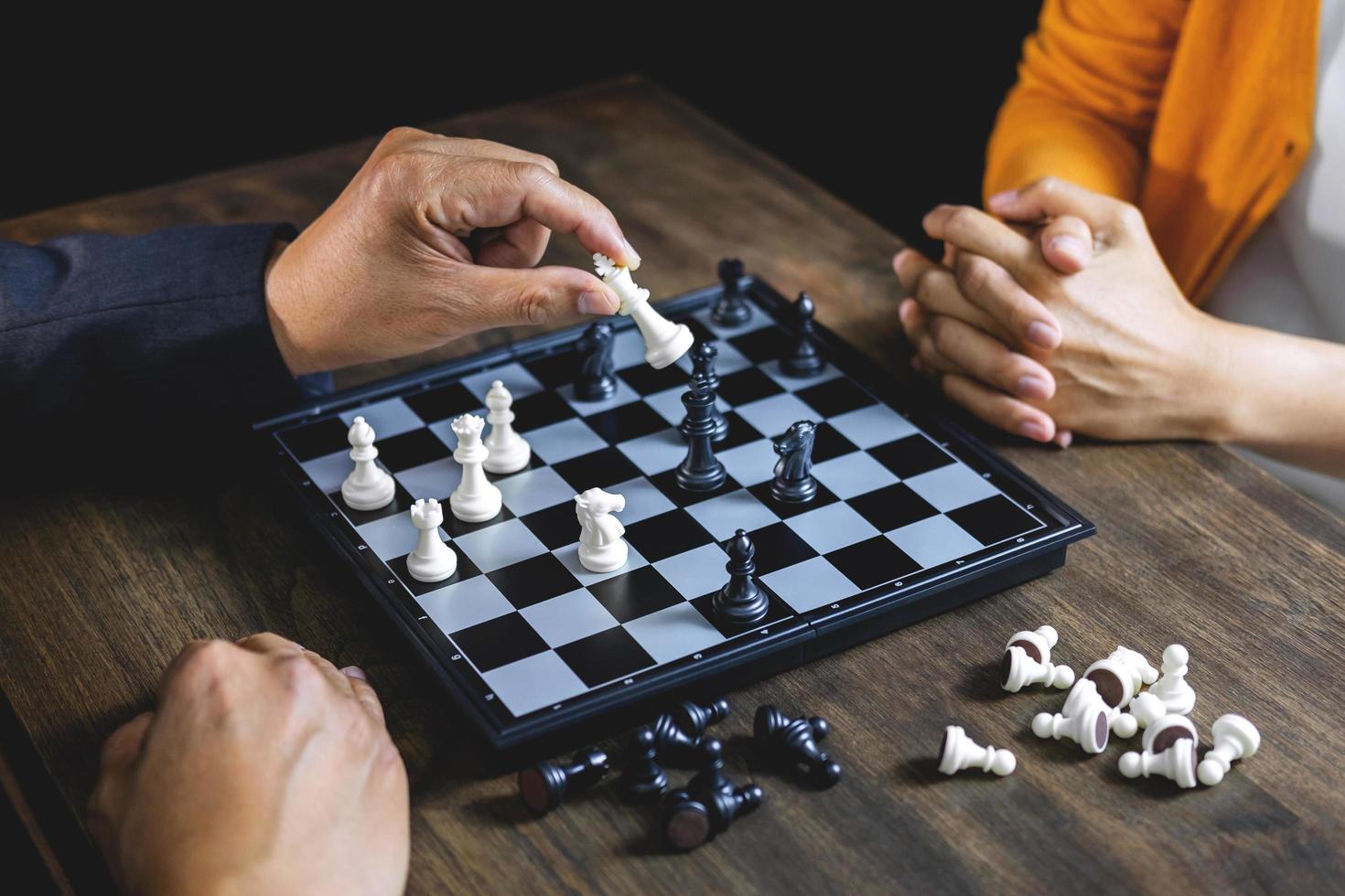 Businessman and businesswoman playing chess  photo