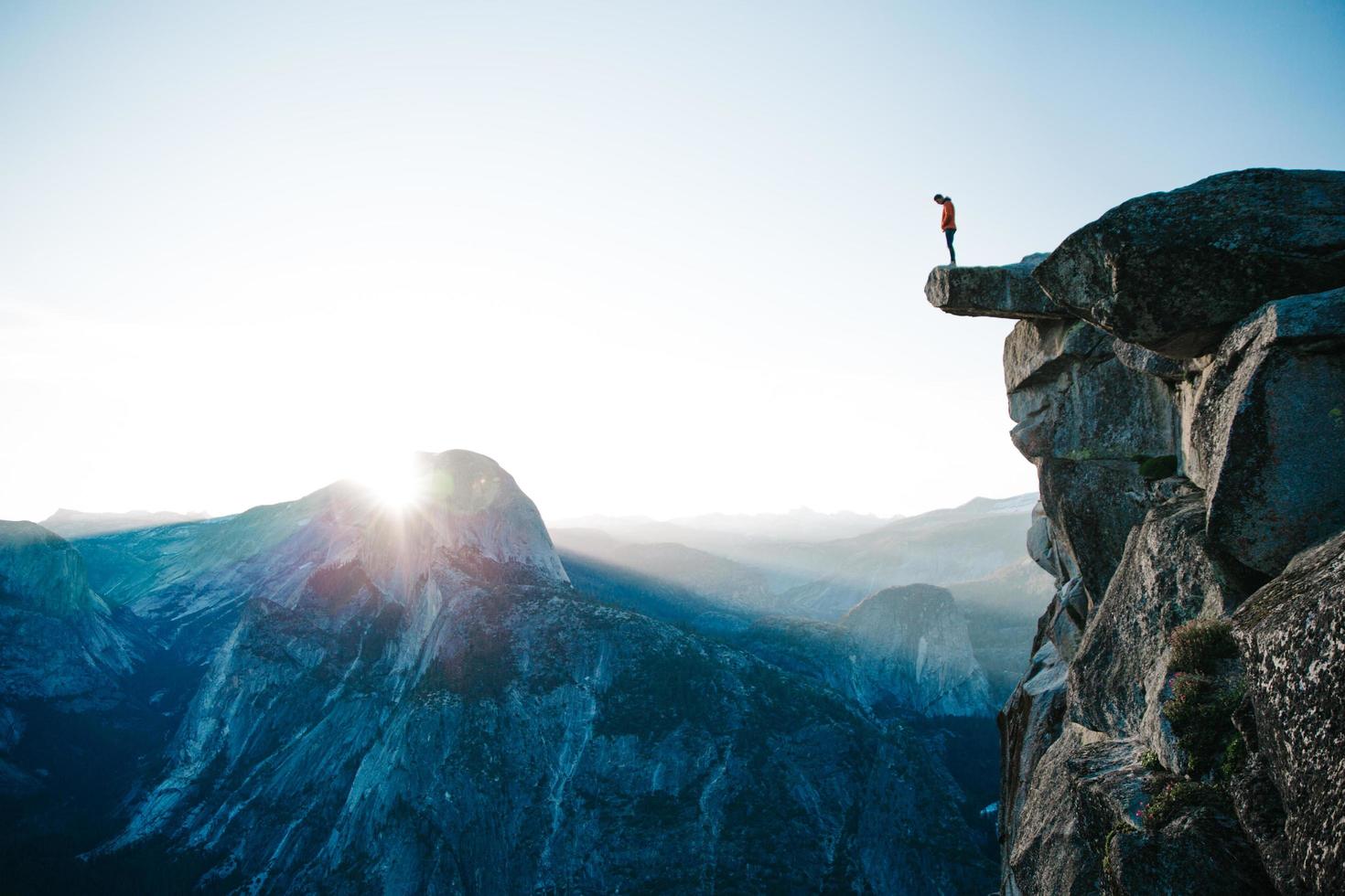 Man standing on cliff at Glacier Point photo