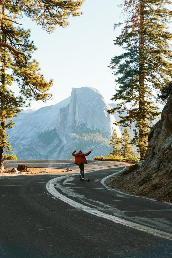 Man skateboarding in front of Half Dome photo