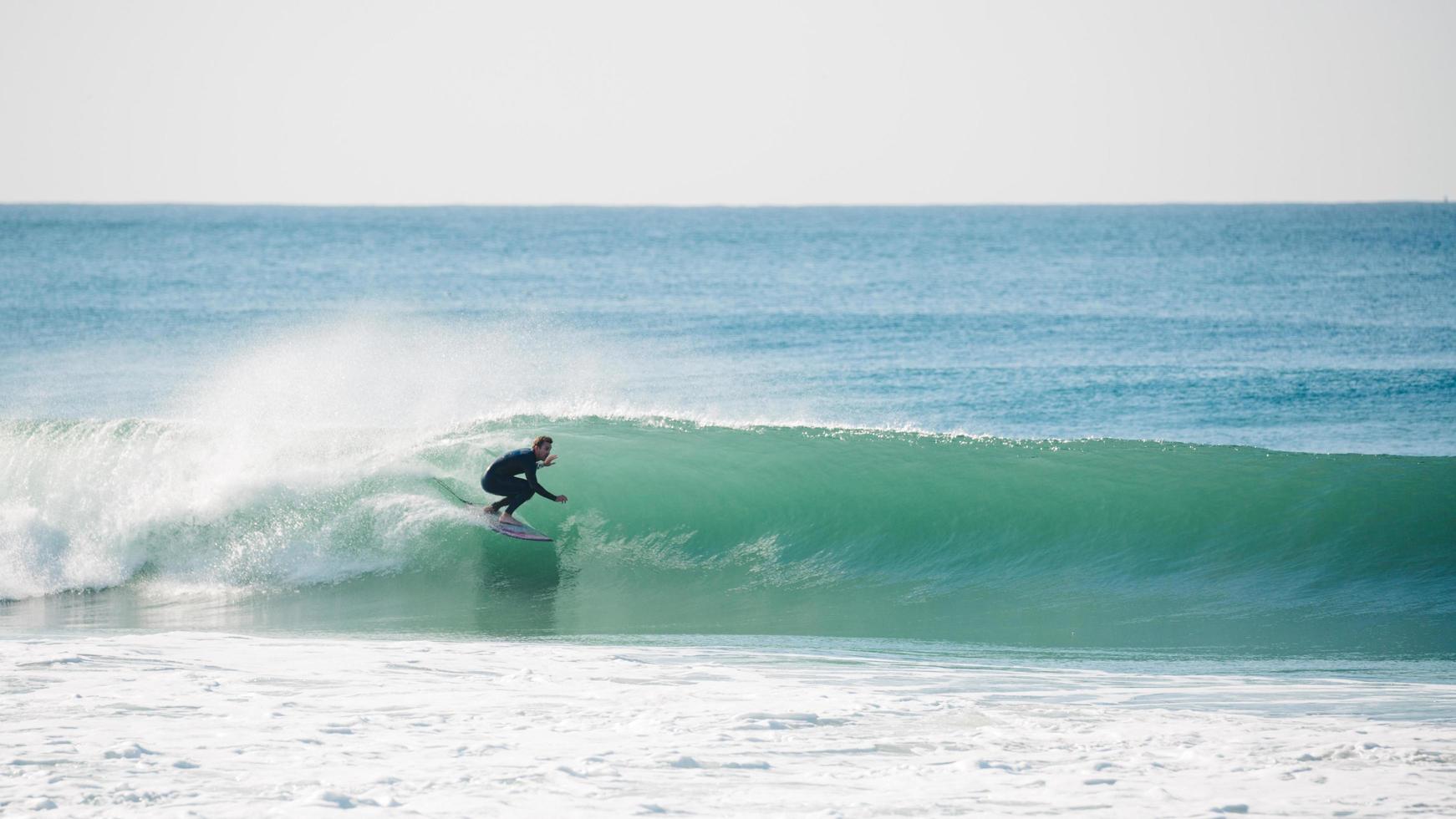 Man surfing on clear wave photo