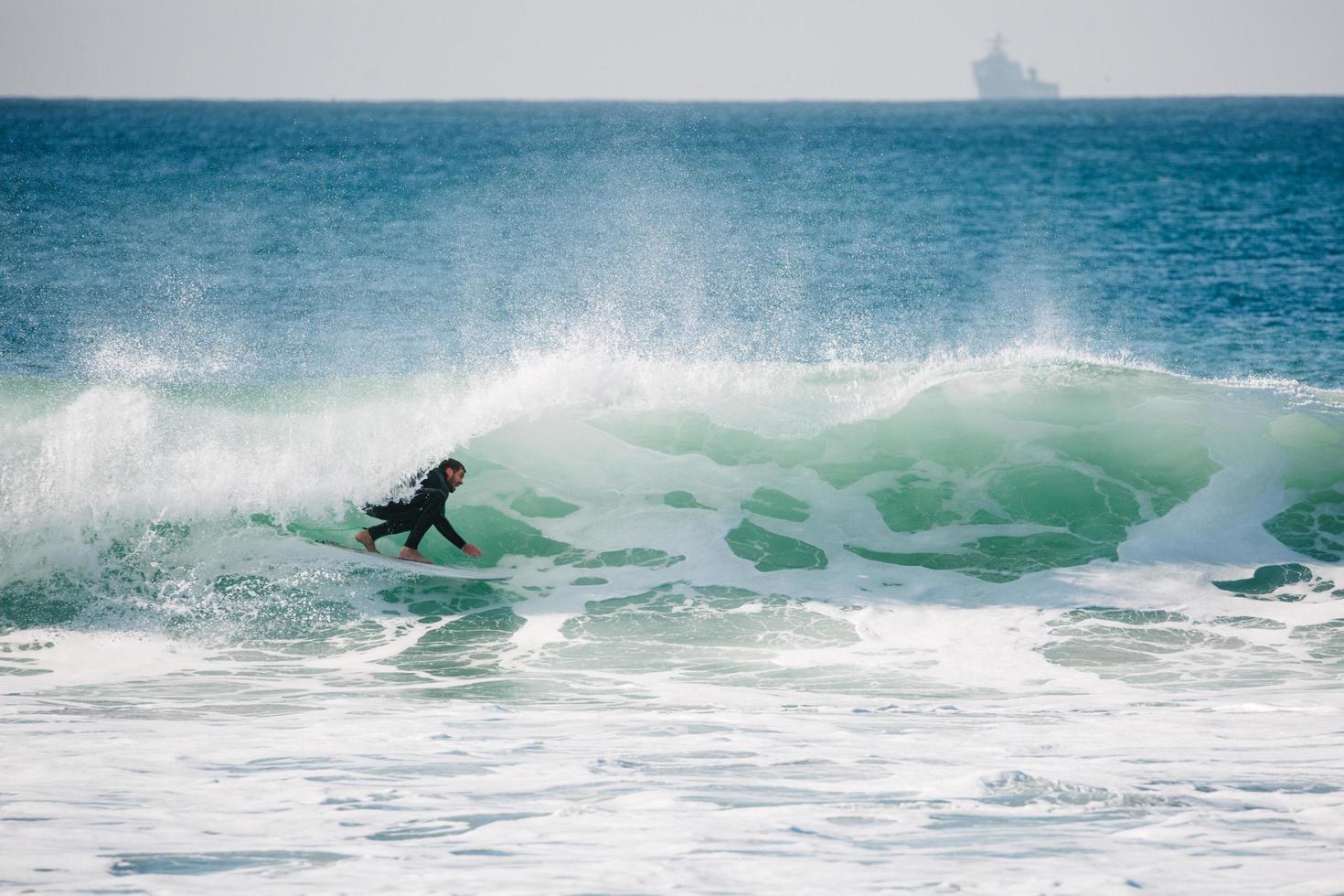 Surfer under barel in California photo