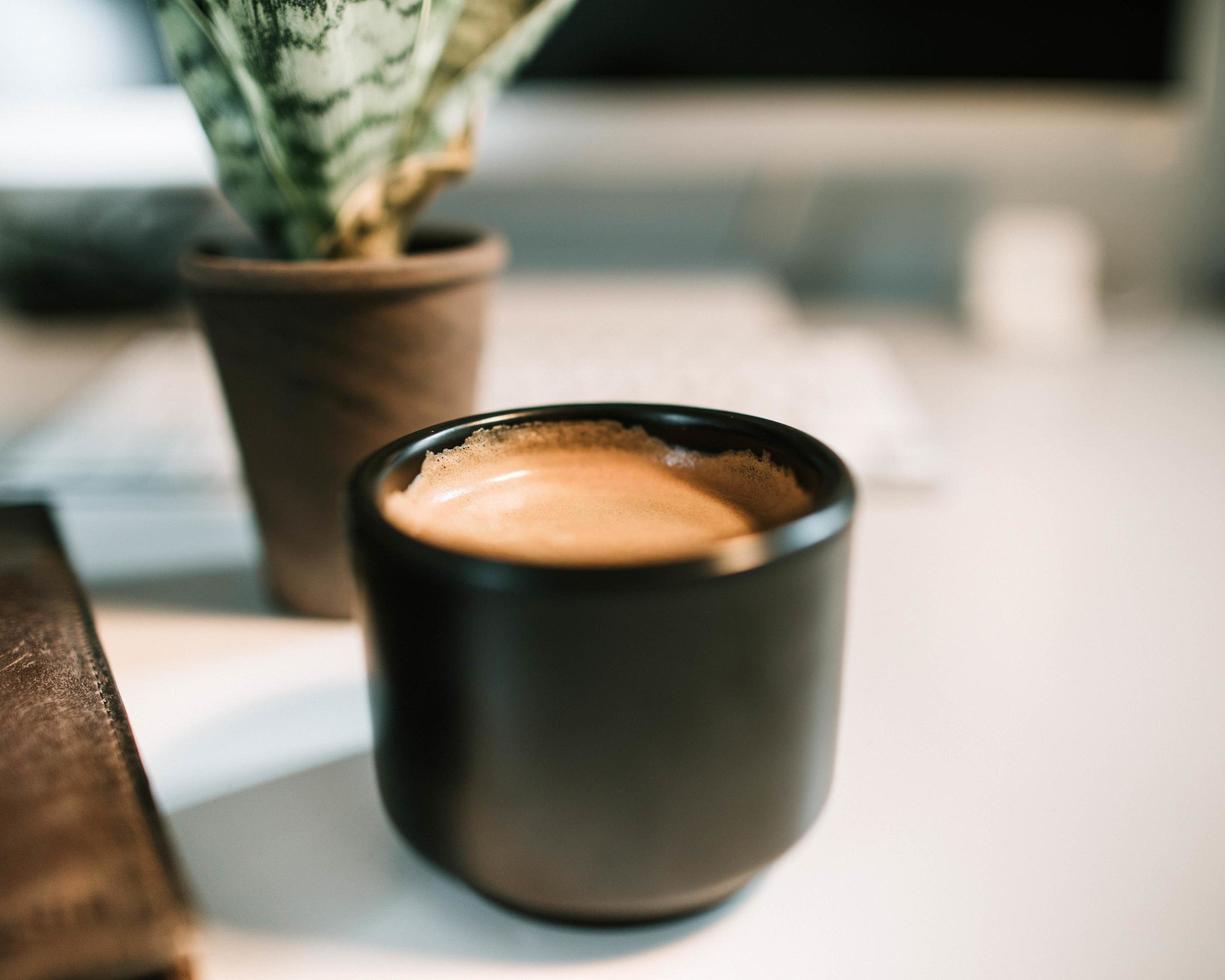 Coffee in black ceramic mug photo