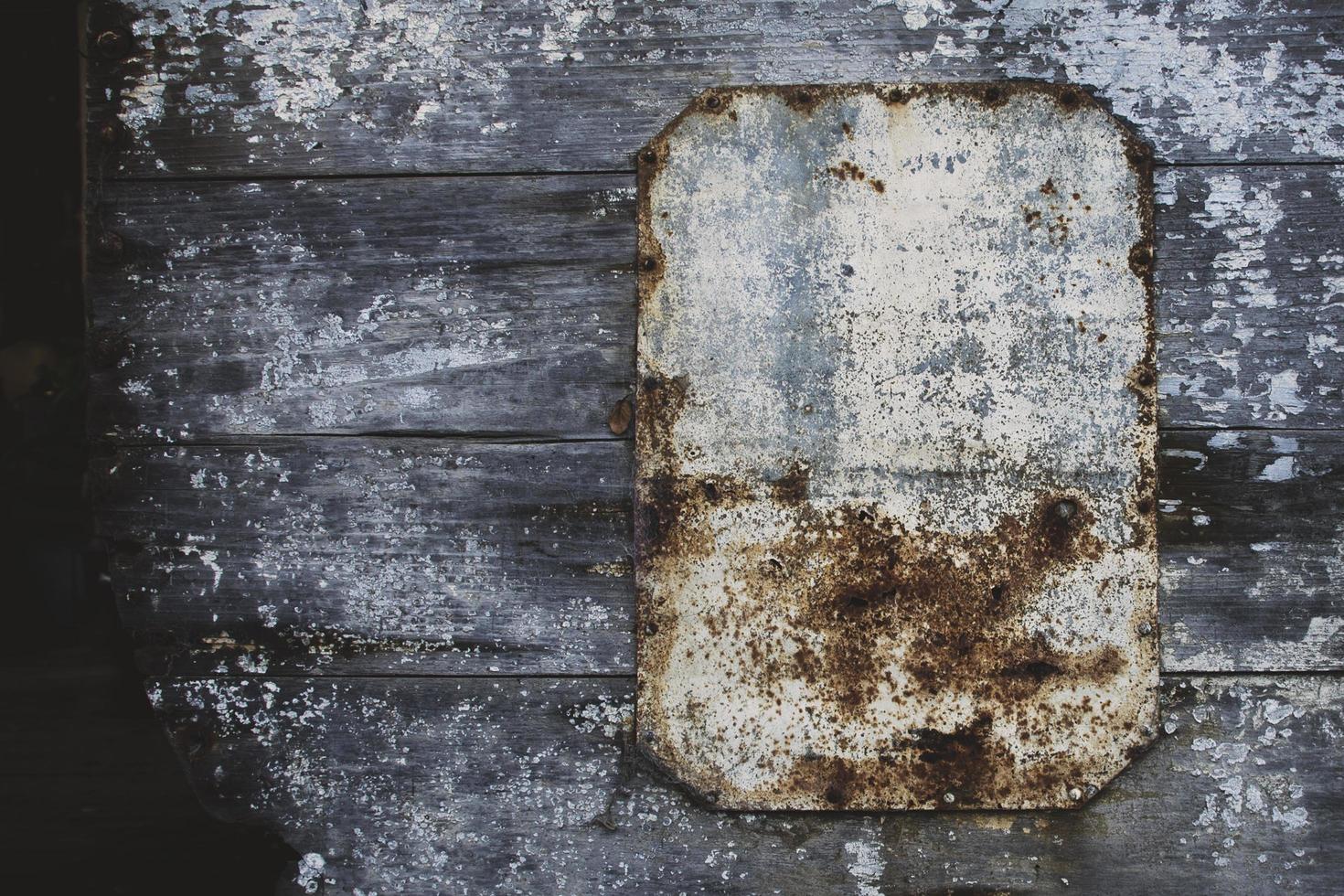 Worn sign on wooden wall photo