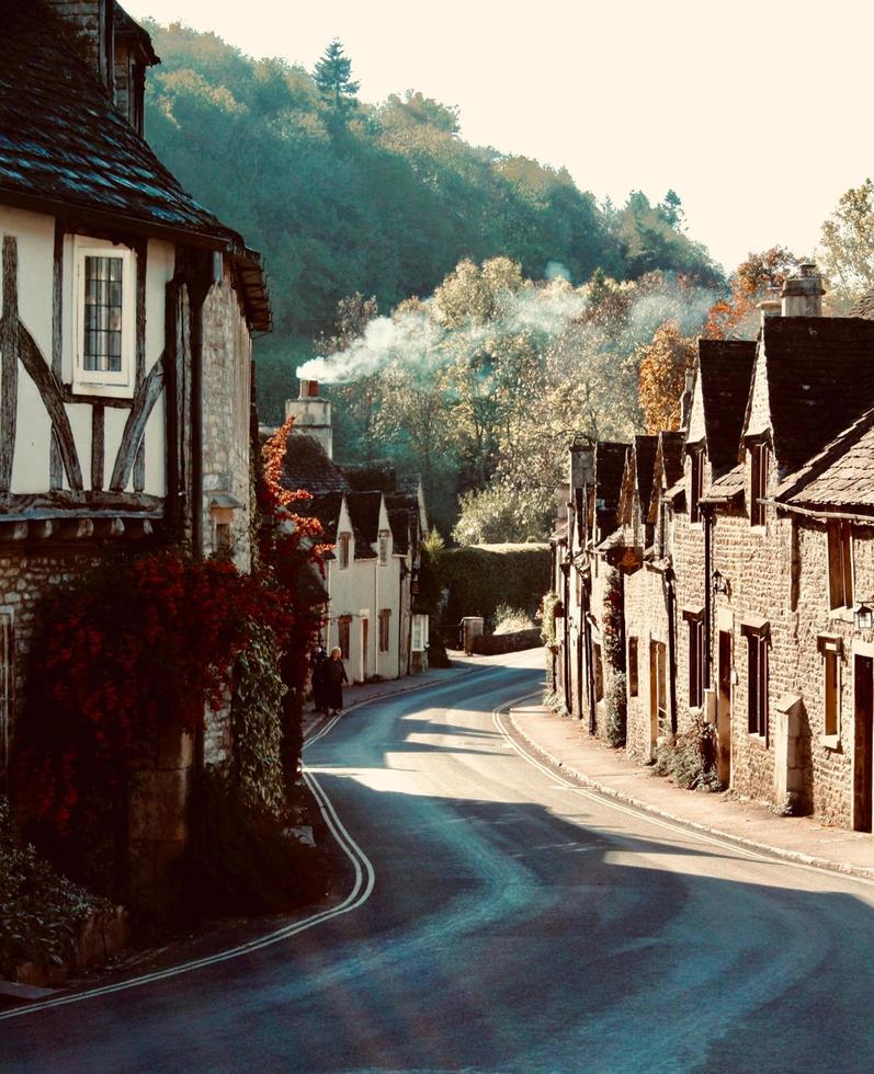 Road between brown brick houses photo