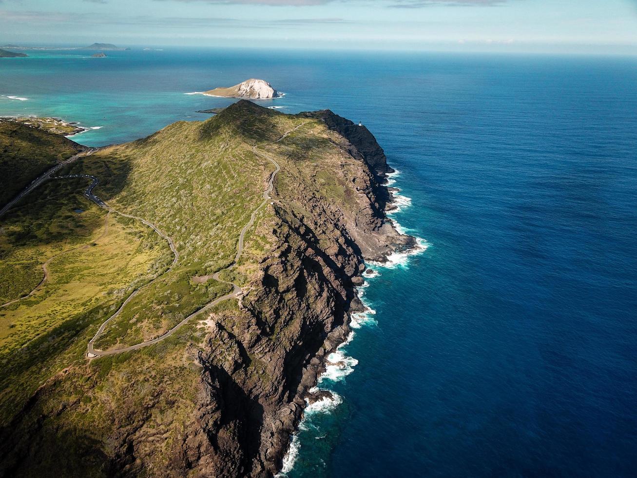 Coastal mountain near body of water photo