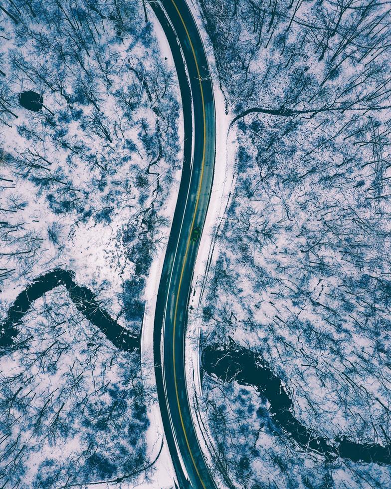 Aerial top-down view of a road in the middle of snow photo
