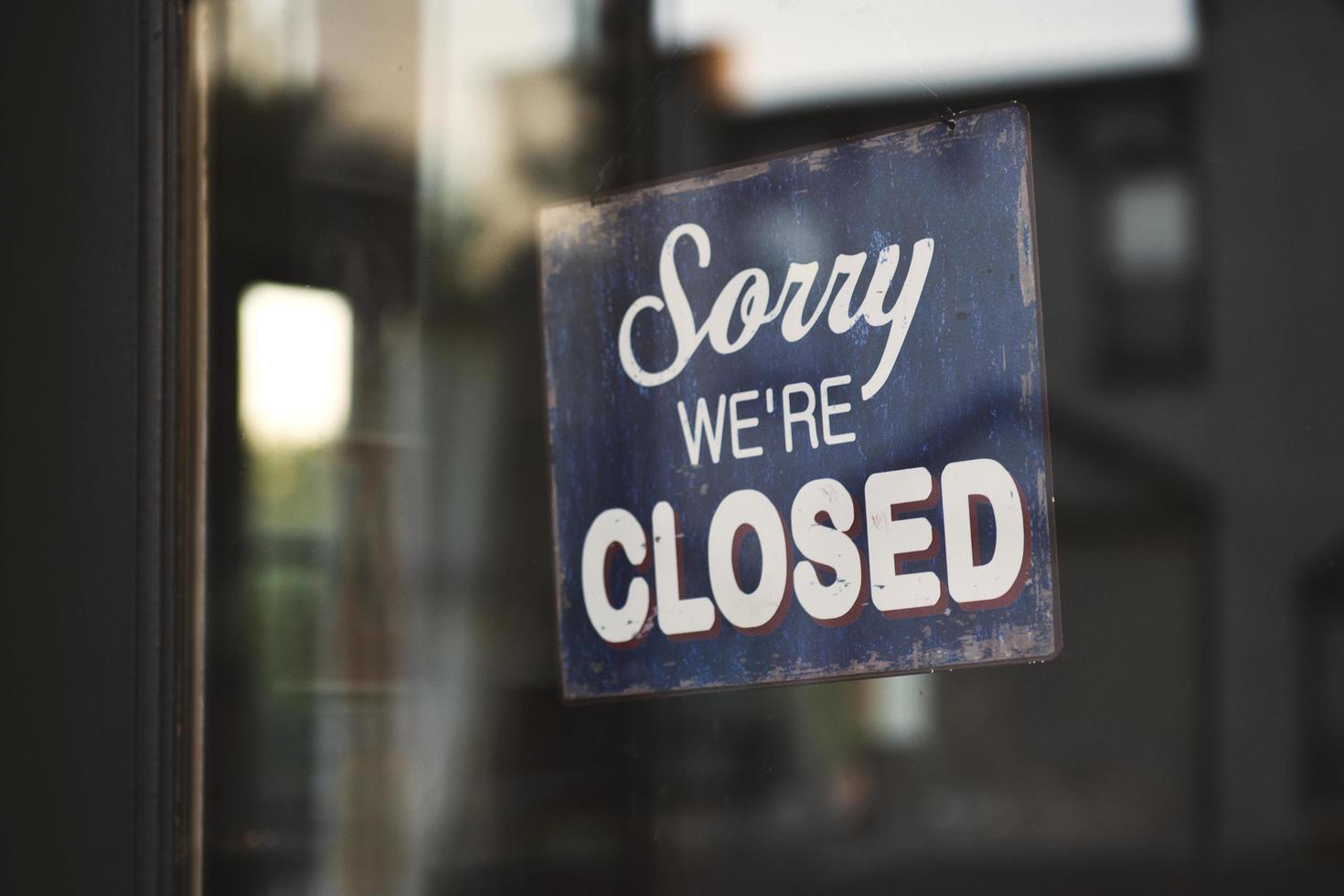 Sorry we're closed sign on glass door photo