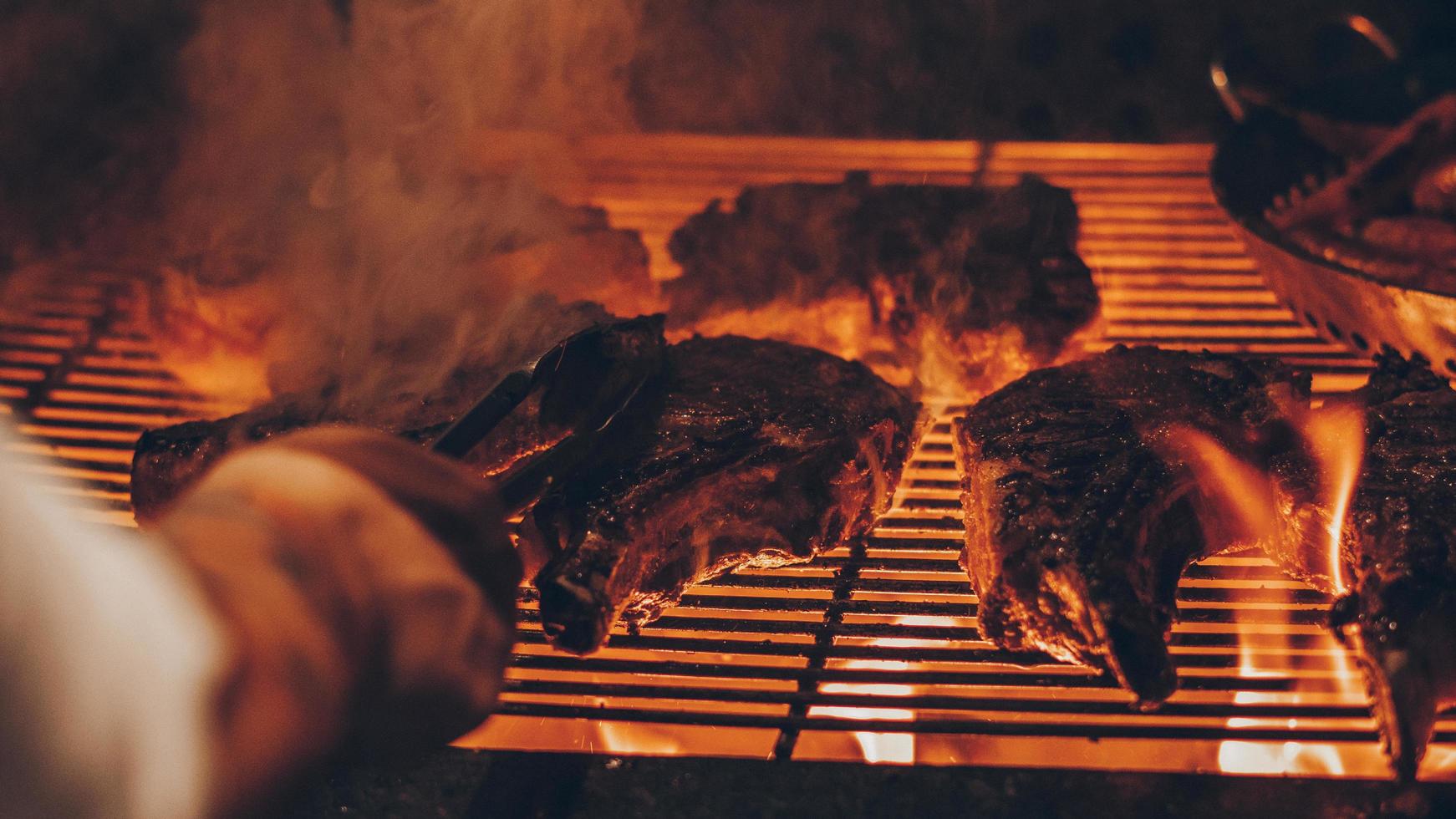 Person grilling meat photo