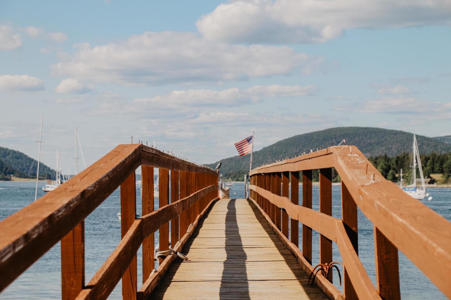 Dock with railing near boats during day photo