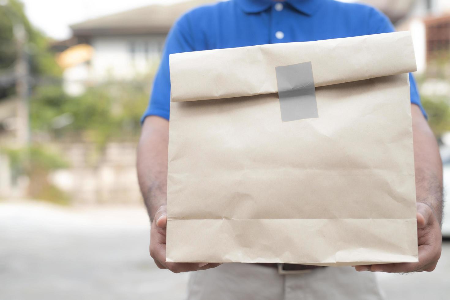 Man holding paper bag photo