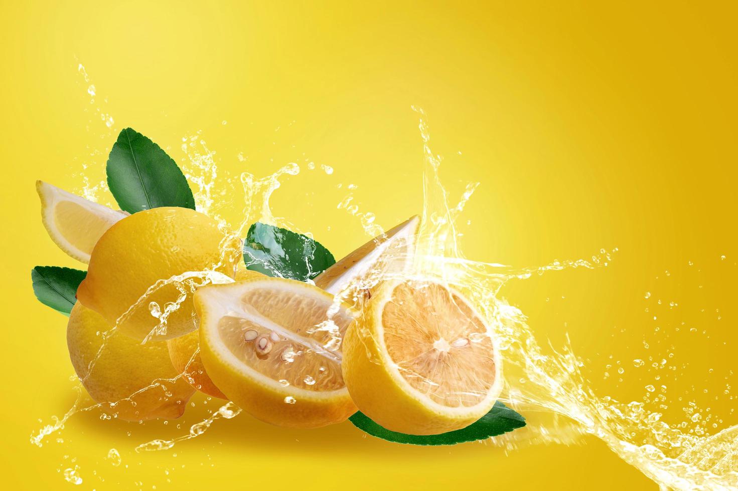 salpicaduras de agua sobre limones amarillos maduros en rodajas frescas foto