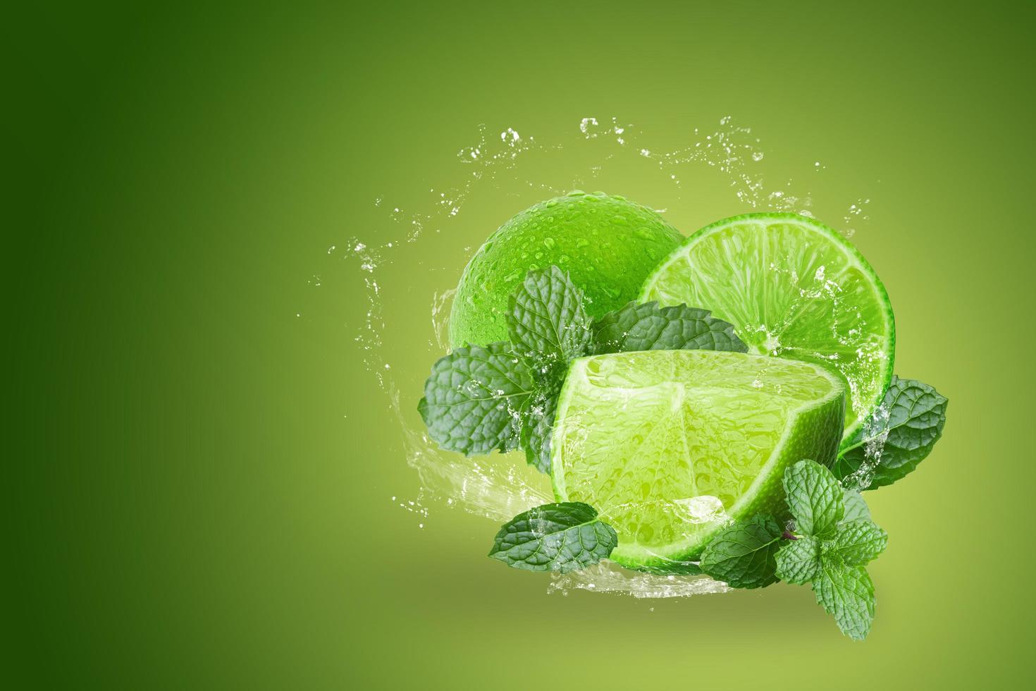 Lemonade splashing on green limes photo