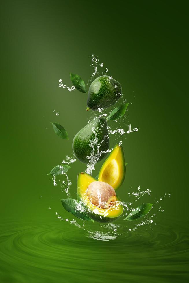Water splashing on fresh sliced green avocado photo