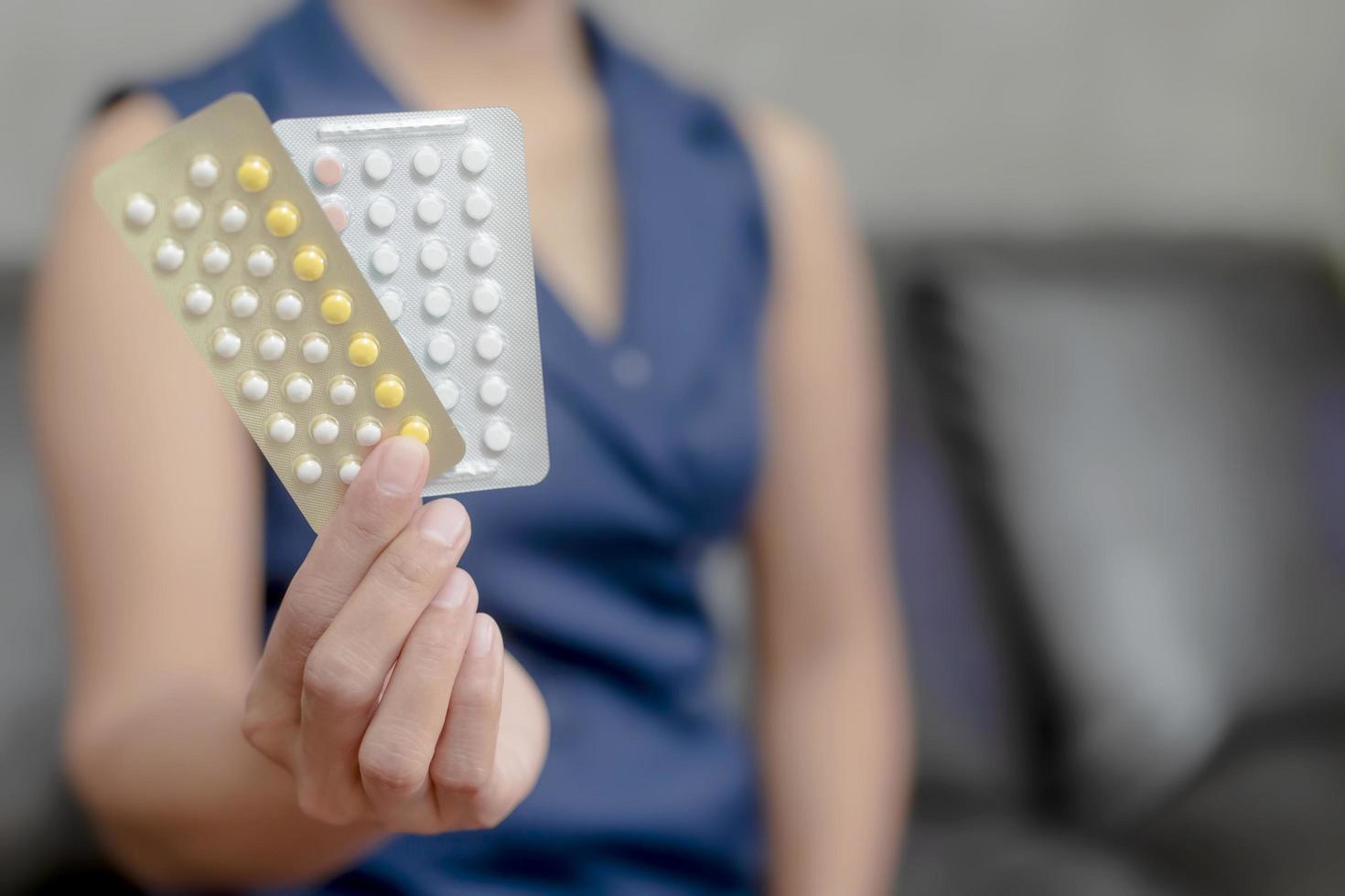 Woman holding birth control photo