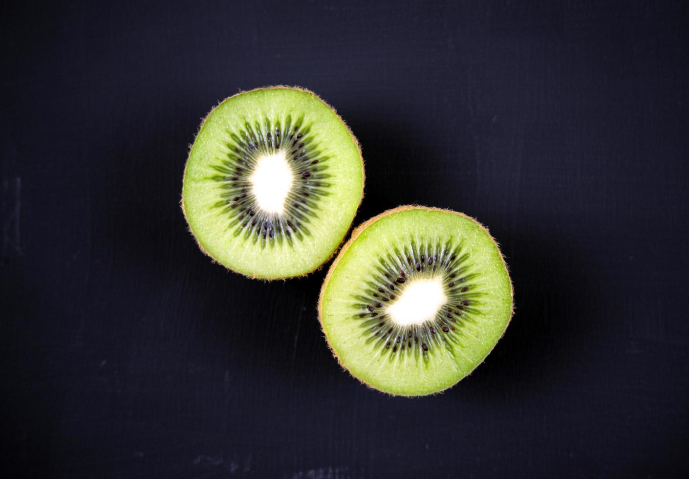 Sliced kiwi on dark background photo